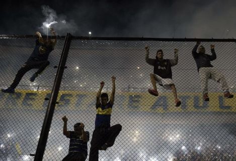 Fans Climbing Over High Security Barriers